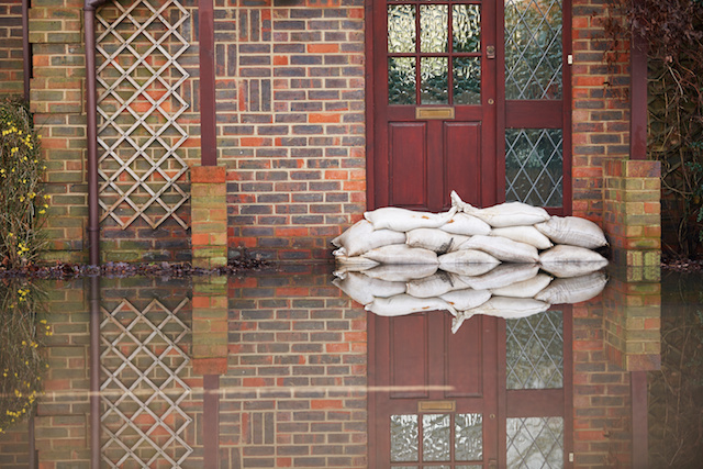 Sandbags Outside Front Door Of Flooded House