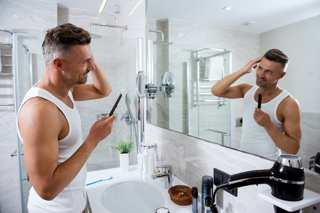 Man at bathroom mirror | Terry's Plumbing Pittsburgh