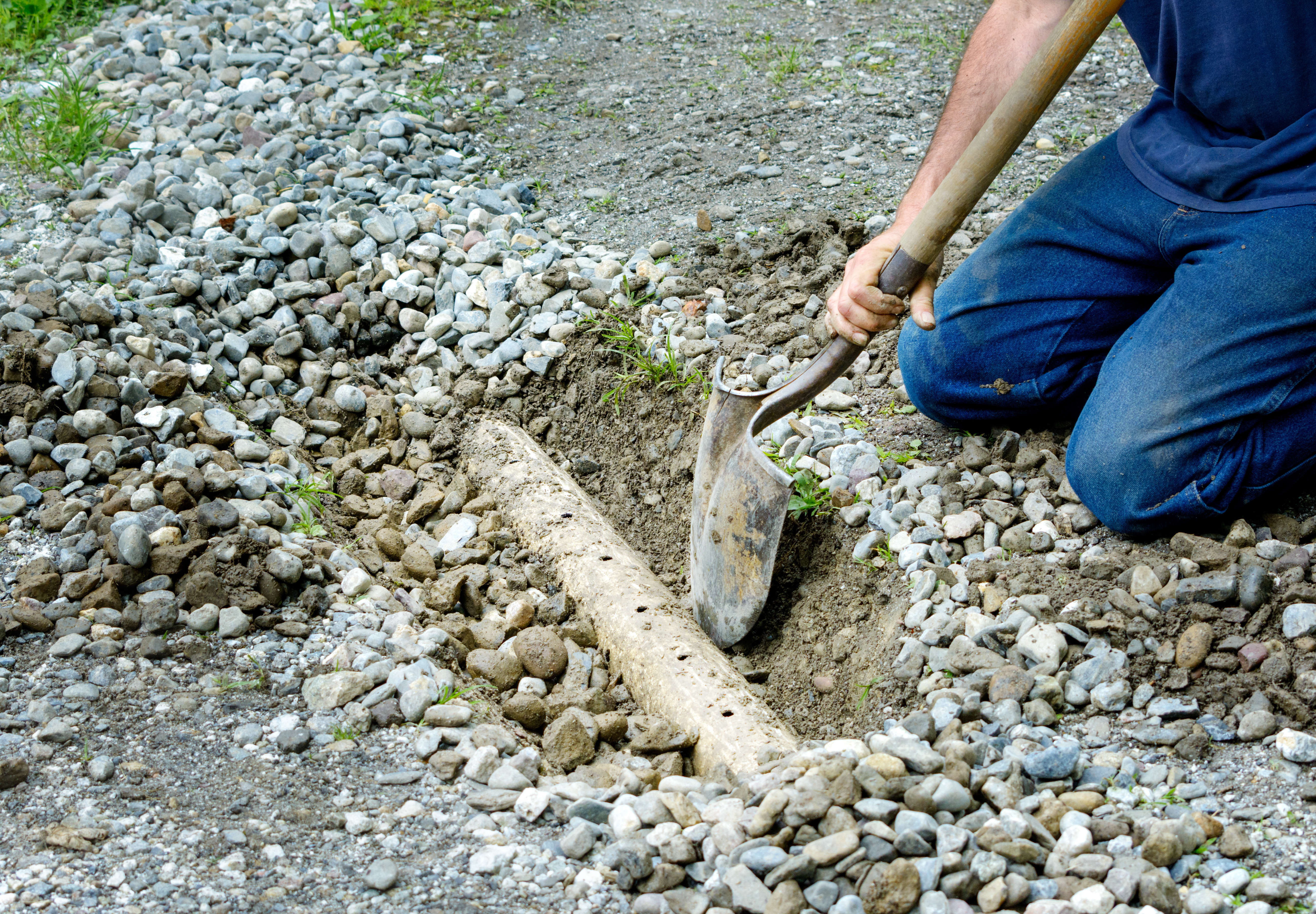 man digging out a french drain