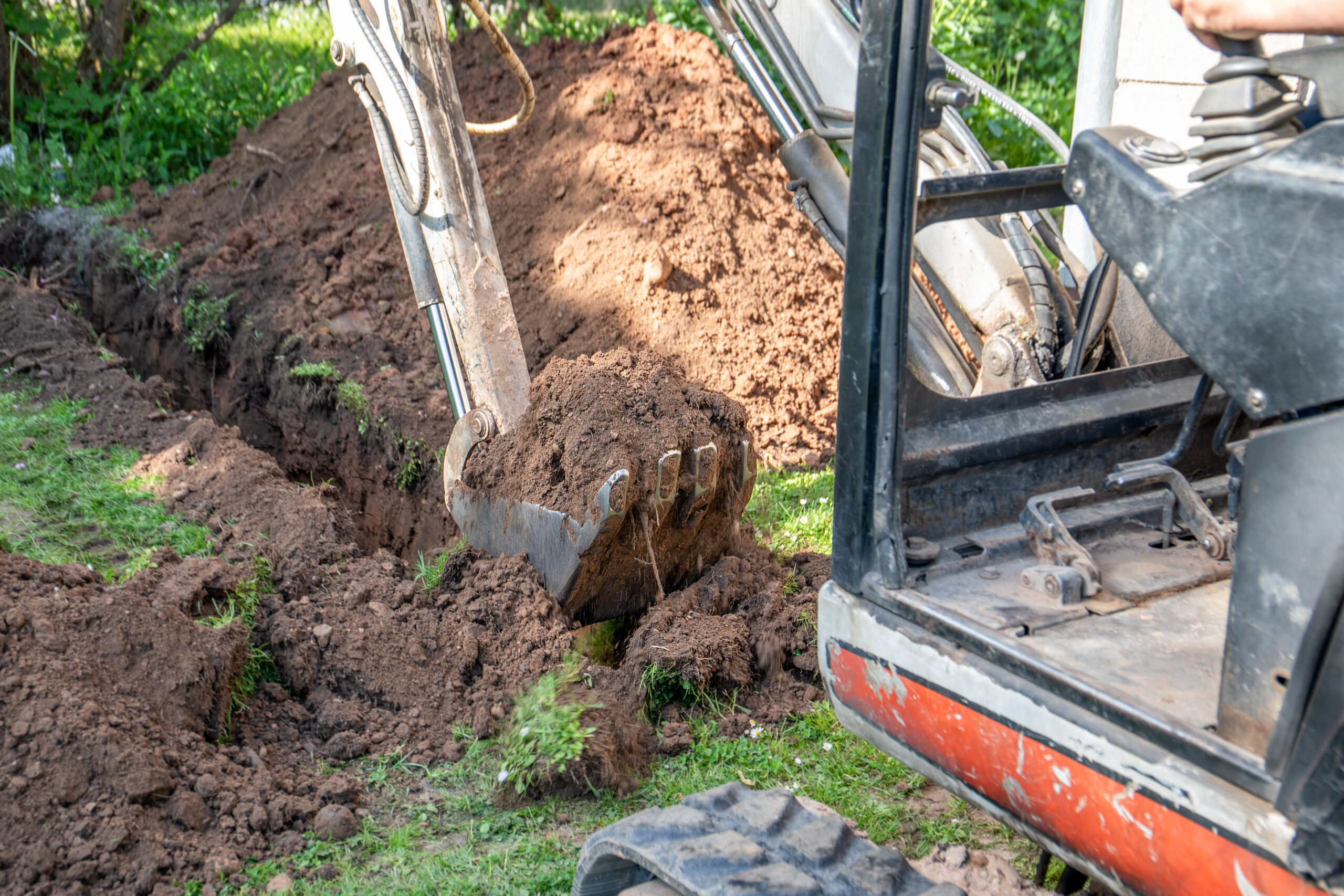 excavator digging a yard